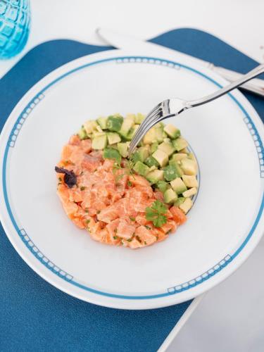 a plate with a bowl of food with a fork at Hotel Quisisana in Capri