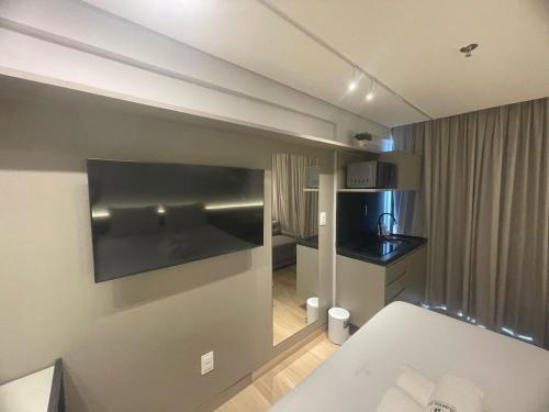 a hotel room with a bed and a kitchen at Setai à beira-mar com rooftop incrível in João Pessoa