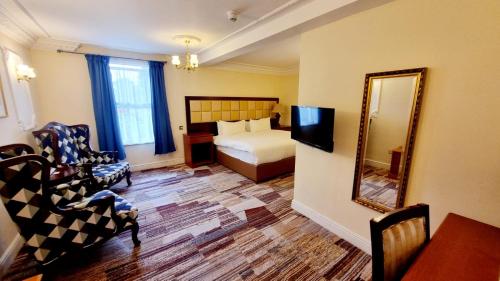 a hotel room with a bed and a mirror at Botleigh Grange Hotel & Spa in Southampton