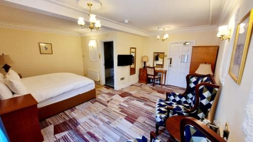 a hotel room with a bed and a tv at Botleigh Grange Hotel & Spa in Southampton