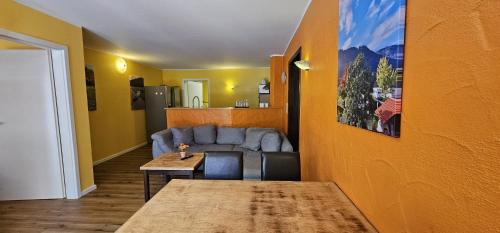 a living room with a couch and a table at Ferienwohnungen am Moselbeach in Mehring