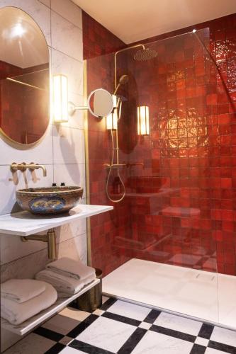 a bathroom with a glass shower with a sink at The Hat Maker Boutique Hotel in Dungarvan
