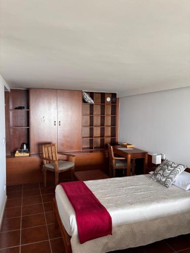 a bedroom with a bed and a dining room at Atlantic - Sea Front in Oia