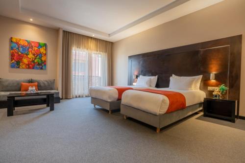 a large bedroom with a large bed and a couch at Kech Boutique Hotel & Spa in Marrakech