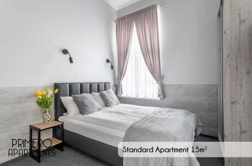 a bedroom with a bed and a window at PRIMERO Elegant Apartments KRAKÓW Old Town in Kraków