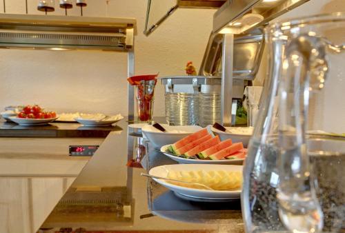 a kitchen with plates of food on a counter at Hotel Hirschenstein in Achslach