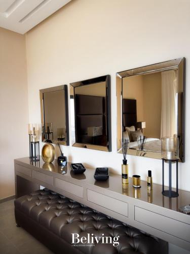a living room with a couch and two mirrors at Villa Continental 4bedrooms in Tangier