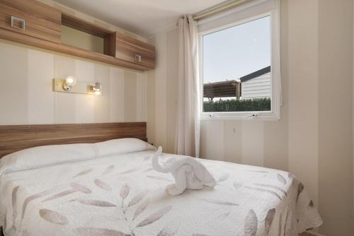 a bedroom with a bed with a stuffed animal on it at Villa Guerrero in Conil de la Frontera