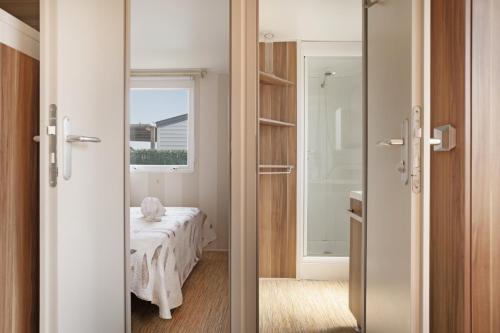 a room with a bed and a glass door at Villa Guerrero in Conil de la Frontera