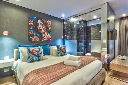 a bedroom with a large bed with blue walls at St Martini Gardens Studio in Cape Town