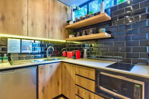 a kitchen with a sink and a dishwasher at St Martini Gardens Studio in Cape Town
