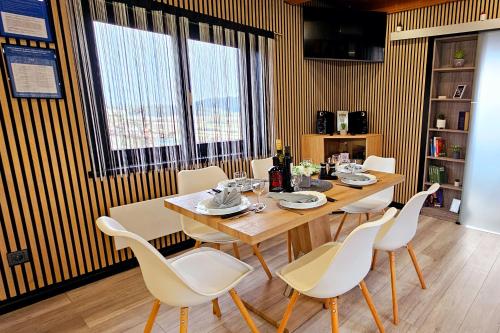 a dining room with a wooden table and white chairs at AquaHaven With Private Pool And Wellness - Happy Rentals in Veliko Trgovišće