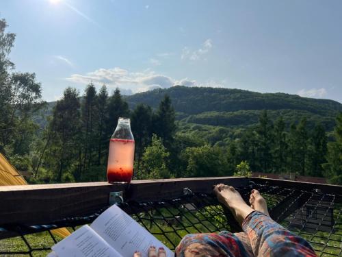 a person with their feet up on a ledge with a drink at Krondorf and Spa Theodor 