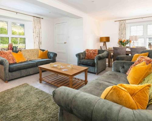 a living room with couches and a coffee table at Melfort Village in Oban