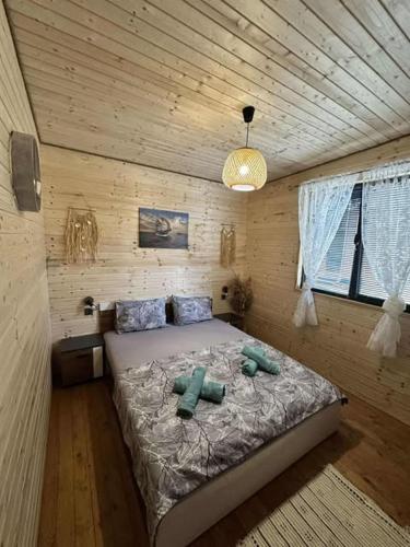 a bedroom with a bed in a wooden room at Еко Къщи Къмпинг Созопол Еко in Sozopol