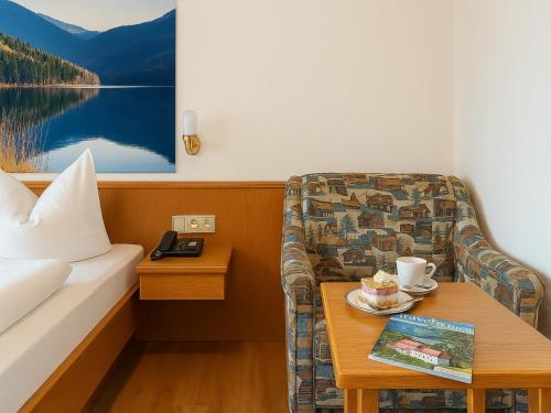a hotel room with a couch and a table at GarniHotel zur Linde - Bayerischer Wald - aktivCard mit 154 kostenfreien Leistungen - kostenloser Parkplatz in Lohberg