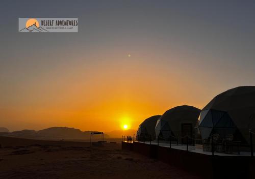 a group of domes in the desert at sunset at Wadi Rum Desert Adventures in Wadi Rum