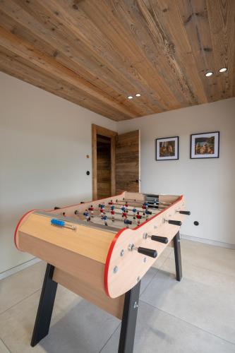a ping pong table in a room at Chalet Le Cocon des Marmottes in Gérardmer