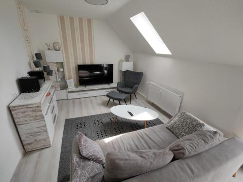 a living room with a couch and a tv at Urlaubszuhause 