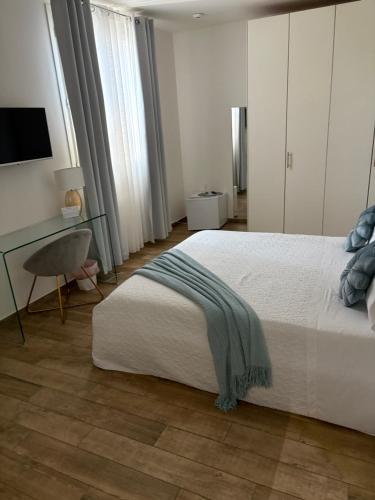 a bedroom with a bed and a desk and a chair at IVY PARK in Medolla