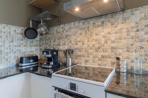 a kitchen with a sink and a counter top at Beau gite avec couloir de nage in Le Garn