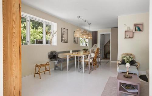 a dining room and living room with a table and chairs at Lovely Home In Tranekær With Wifi in Tranekær