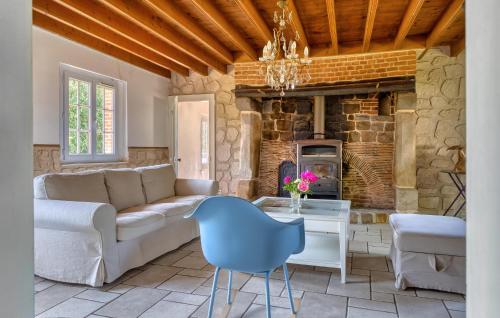 a living room with a couch and a table at Athentique Maison Normande in Vénesville