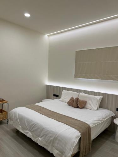 a bedroom with a large white bed with two pillows at 小島之後After Island in Liu-ch'iu Yü