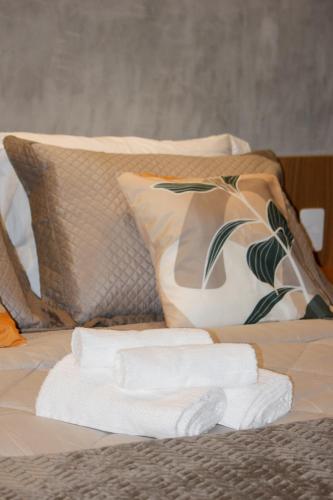 a pile of towels sitting on top of a bed at Studio 3 min from the subway - Complete and well located in Sao Paulo