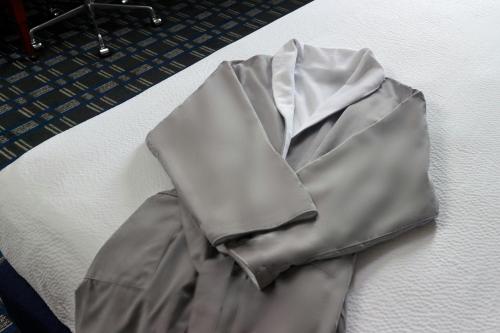 a wrinkled gray shirt laying on a bed at Courtyard Arlington Crystal City/Reagan National Airport in Arlington