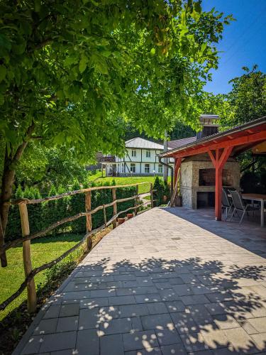 a walkway with a wooden fence and a building at Vikendica Stella in Bihać