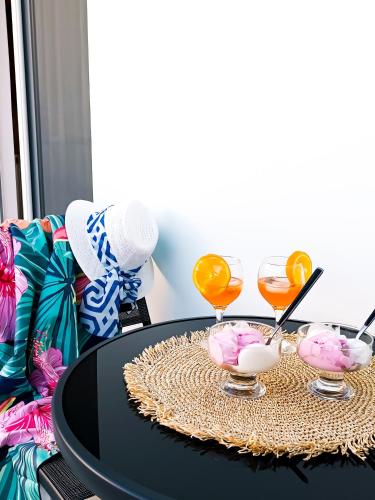 a black table with three glasses on a table at Seaside Breeze Apartment in Sitia