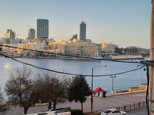 a view of a city with a bridge over a river at Cozy Seaview Apartment Sliema S6 in Sliema