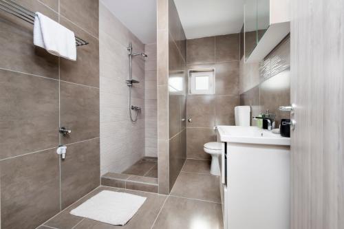 a bathroom with a shower and a toilet and a sink at Apartman Babich in Rovinj