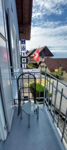 a chair on a balcony with a view of a street at Le BéliMont Panorama in Belmont-sur-Lausanne