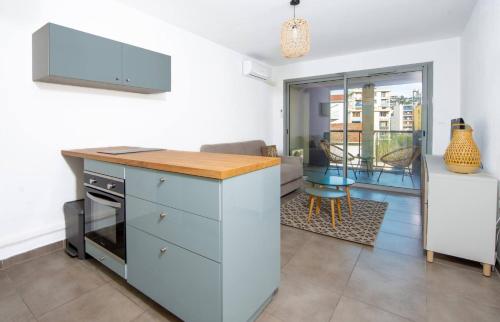 une cuisine avec un comptoir et un salon dans l'établissement Studio Port Golfe-Juan Parking Wifi Climatisation Terrasse, à Vallauris