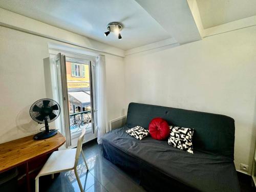 un salon avec un canapé et une fenêtre dans l'établissement Studio Nice Port BONAPARTE Place du Pin, à Nice