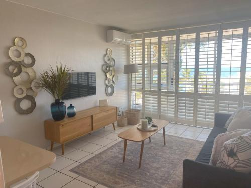 a living room with a couch and a table at Chaka's Cove 74 in Ballito