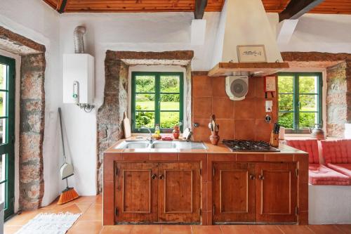 a kitchen with a sink and a stove at Quinta das Queimadas in Nordeste