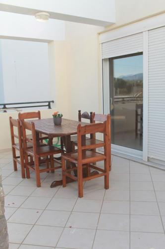 a wooden table and two chairs on a patio at Villa Aphrodity in Kos Town