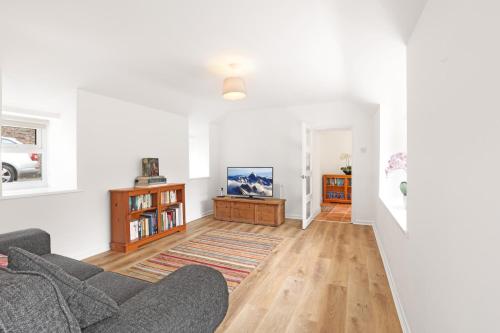a living room with a couch and a table at Newton House - North East Escapes in Newton by the Sea