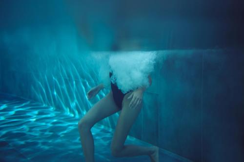 a woman in the water with a cloud on her head at El Vicenç de la Mar - Adults Only - Over 12 in Pollença