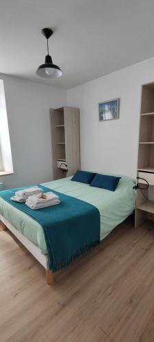 une chambre avec un grand lit avec une couverture bleue dans l'établissement Beau T2 Trégastel avec jardin, proche plages et commerces, à Trégastel