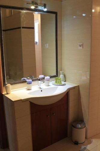 a bathroom with a sink and a mirror at Villa Aphrodity in Kos Town