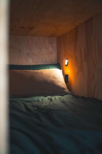 a bedroom with a bed and a light on the wall at Altair in Holywell