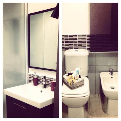 a bathroom with a toilet and a sink and a mirror at Casa Santiago in Gela