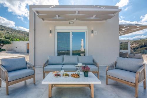 a living room with two chairs and a table at Casa Elea in Kissamos