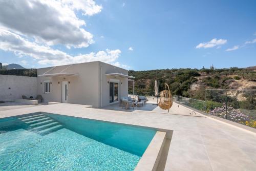 a villa with a swimming pool and a house at Casa Elea in Kissamos