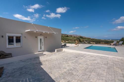 a villa with a swimming pool and a house at Casa Elea in Kissamos