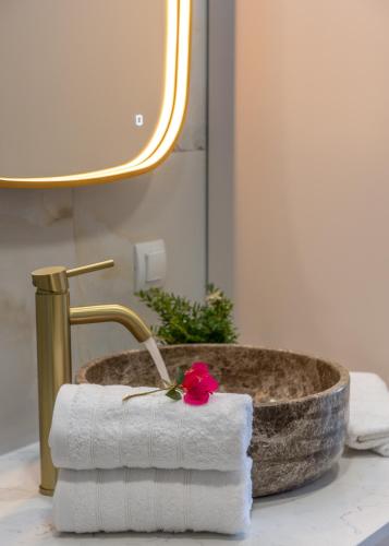 a bathroom with a stone sink with a rose on it at Casa Elea in Kissamos